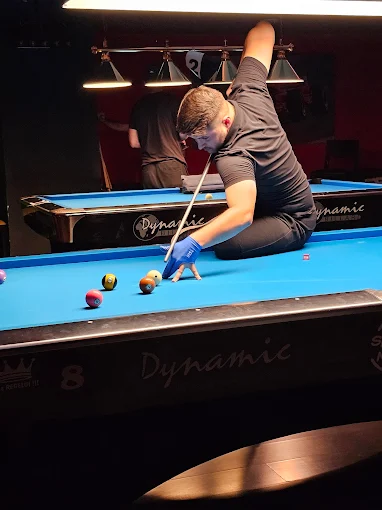 Player in action at the Mercury 8-ball table